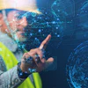 Worker in safety vest interacting with futuristic digital holographic globe interface