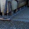 Industrial machinery edge with metal components and textured surface