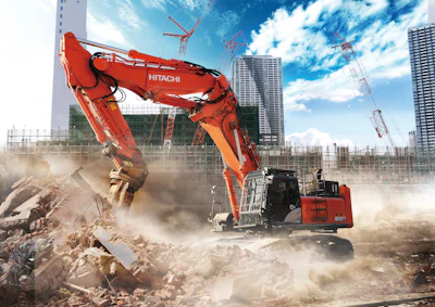Red Hitachi excavator demolishing building debris on urban construction site with skyscrapers and cranes in background