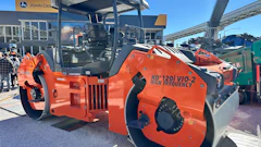 Orange Hamm HD120i VIO-2 vibratory roller compactor on display at outdoor equipment dealership