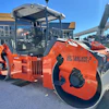 Orange Hamm HD120i VIO-2 vibratory roller compactor on display at outdoor equipment dealership