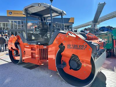 Orange Hamm HD120i VIO-2 vibratory roller compactor on display at outdoor equipment dealership
