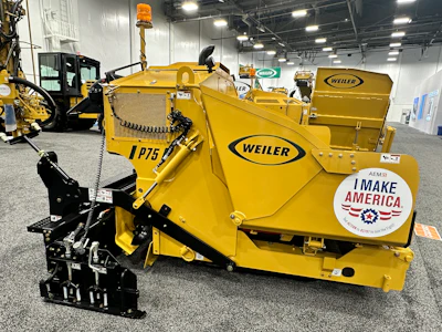 Yellow Weiler industrial wood chipper with black mechanical components displayed at trade show