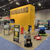 Vanguard yellow exhibition booth at a trade show convention center with arcade games and displays
