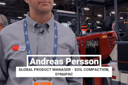 Andreas Persson, Global Product Manager for Soil Compaction at Dynapac, standing at exhibition booth with red compaction equipment