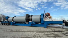 Large blue industrial dryer unit mounted on multi-axle trailer in outdoor lot