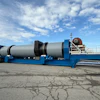 Large blue industrial dryer unit mounted on multi-axle trailer in outdoor lot