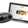 Tablet displaying 3D design software with yellow race car model and external camera sensor device
