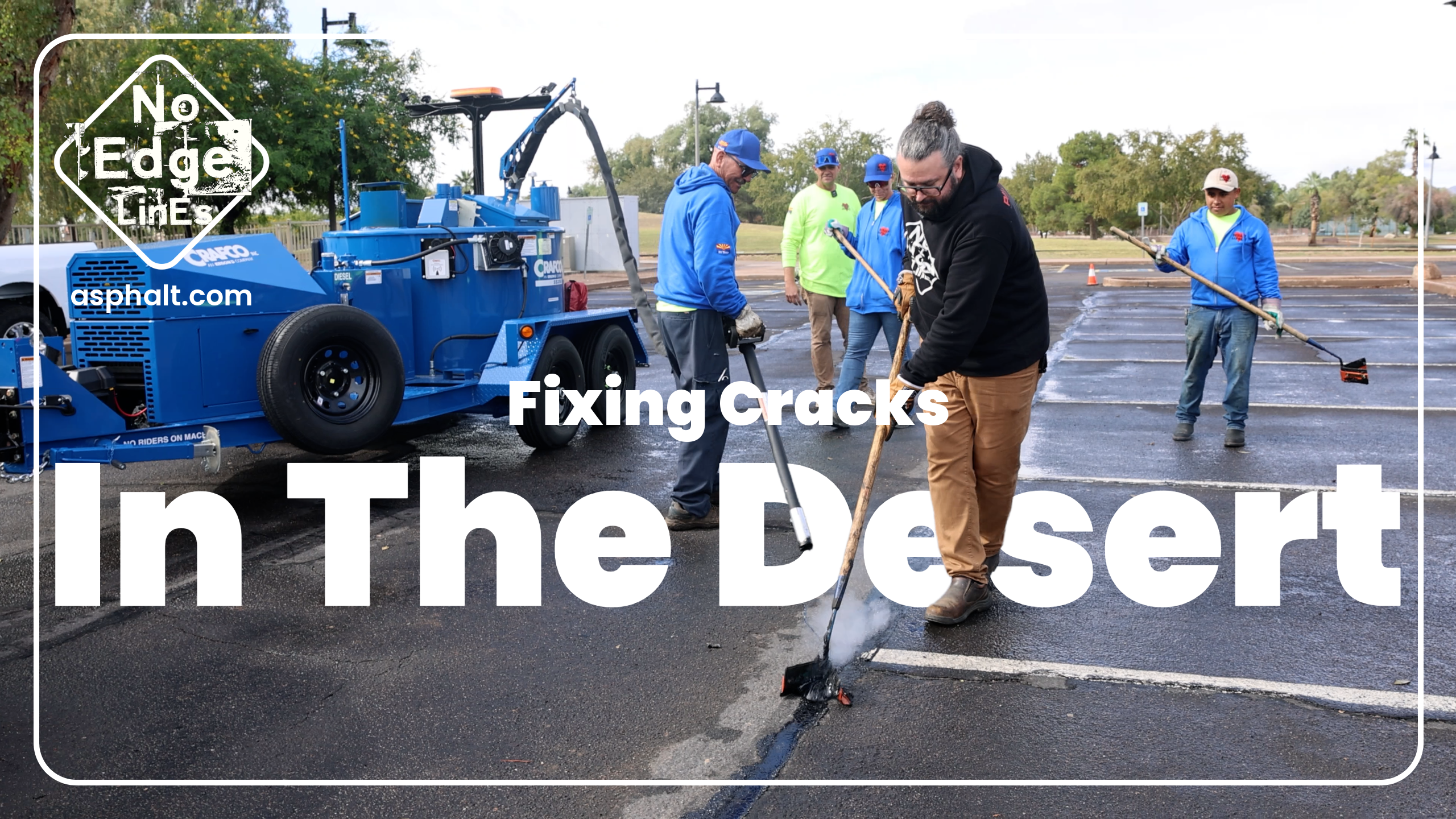 Asphalt repair crew filling cracks in desert parking lot with blue equipment and workers