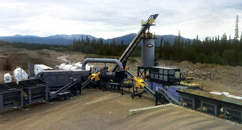 Mobile aggregate processing plant with conveyor systems and heavy equipment in mountainous terrain