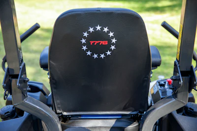 Black motorcycle seat headrest with circular patriotic emblem featuring 13 white stars and red '1776' text