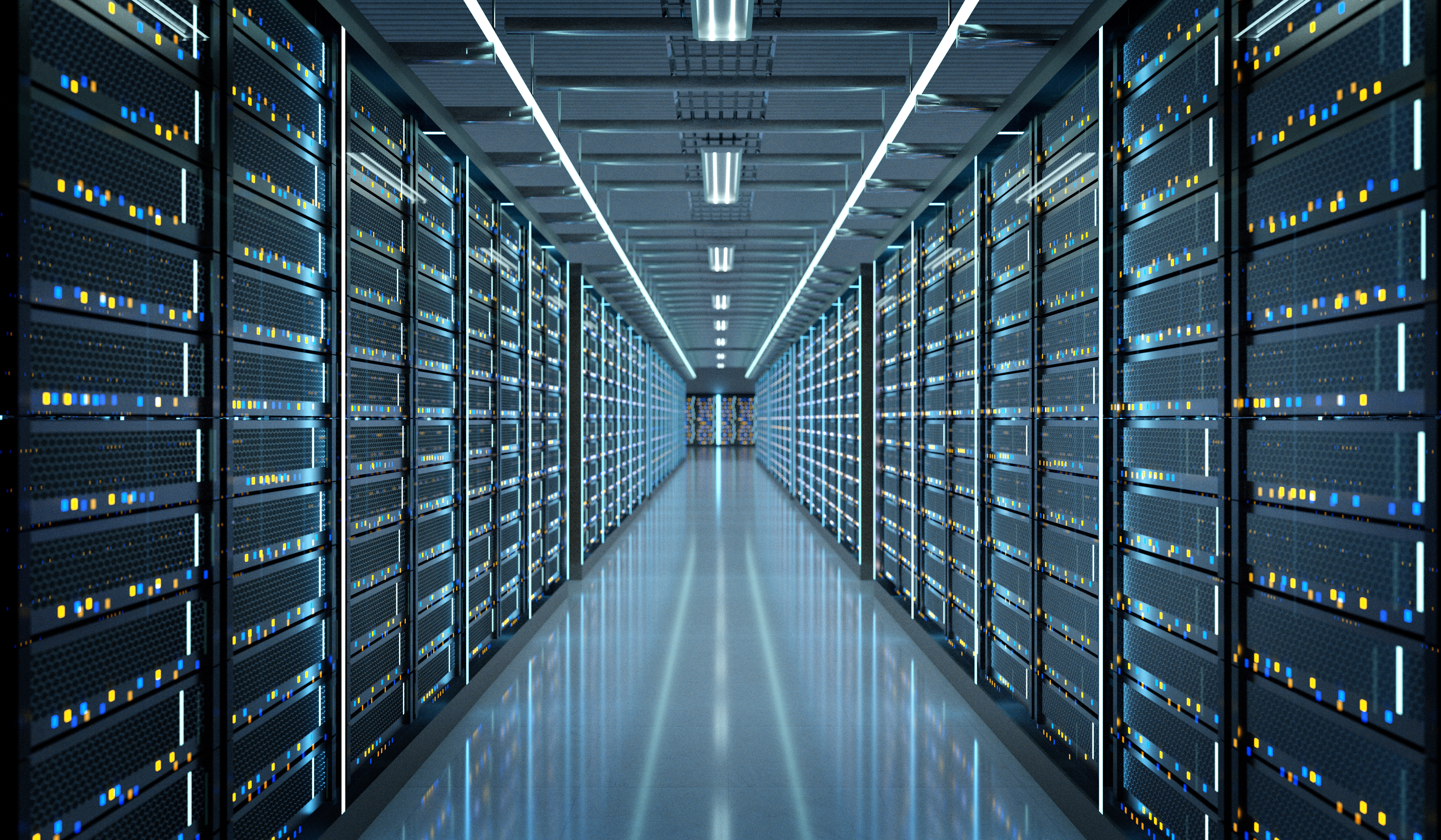 Modern data center with rows of server racks illuminated by blue and yellow indicator lights under fluorescent ceiling panels