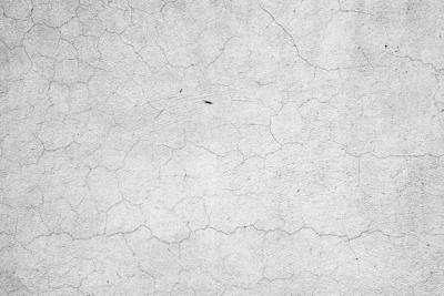 Cracked concrete surface with fine fracture lines and weathered texture