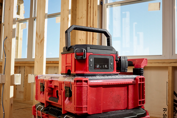 Red and black portable power station stacked on storage cases in construction framing