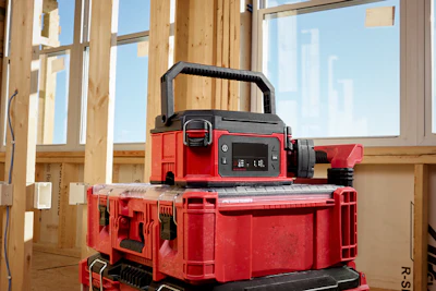 Red and black portable power station stacked on storage cases in construction framing