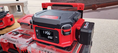 Milwaukee M18 red and black jobsite radio with digital display and storage cases