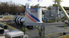 Gencor University Training Center industrial facility with blue and red striped branding, equipment towers, and flags