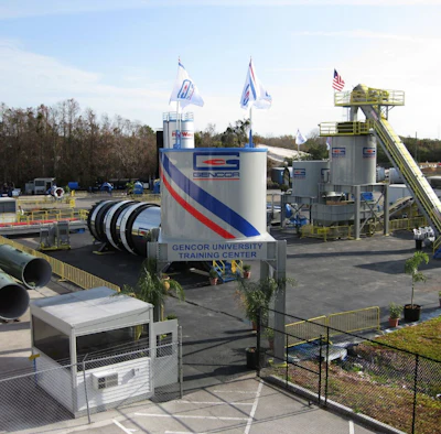 Gencor University Training Center industrial facility with blue and red striped branding, equipment towers, and flags