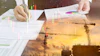 Business professional analyzing financial charts and construction project data with colorful graphs and sunset construction site overlay