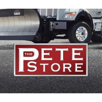 PETE Store red and white rectangular sign on pavement with delivery truck in background