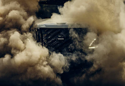 Volvo truck engulfed in dust clouds during high-speed off-road driving