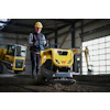 Construction worker operating yellow Wacker Neuson compactor in industrial warehouse setting